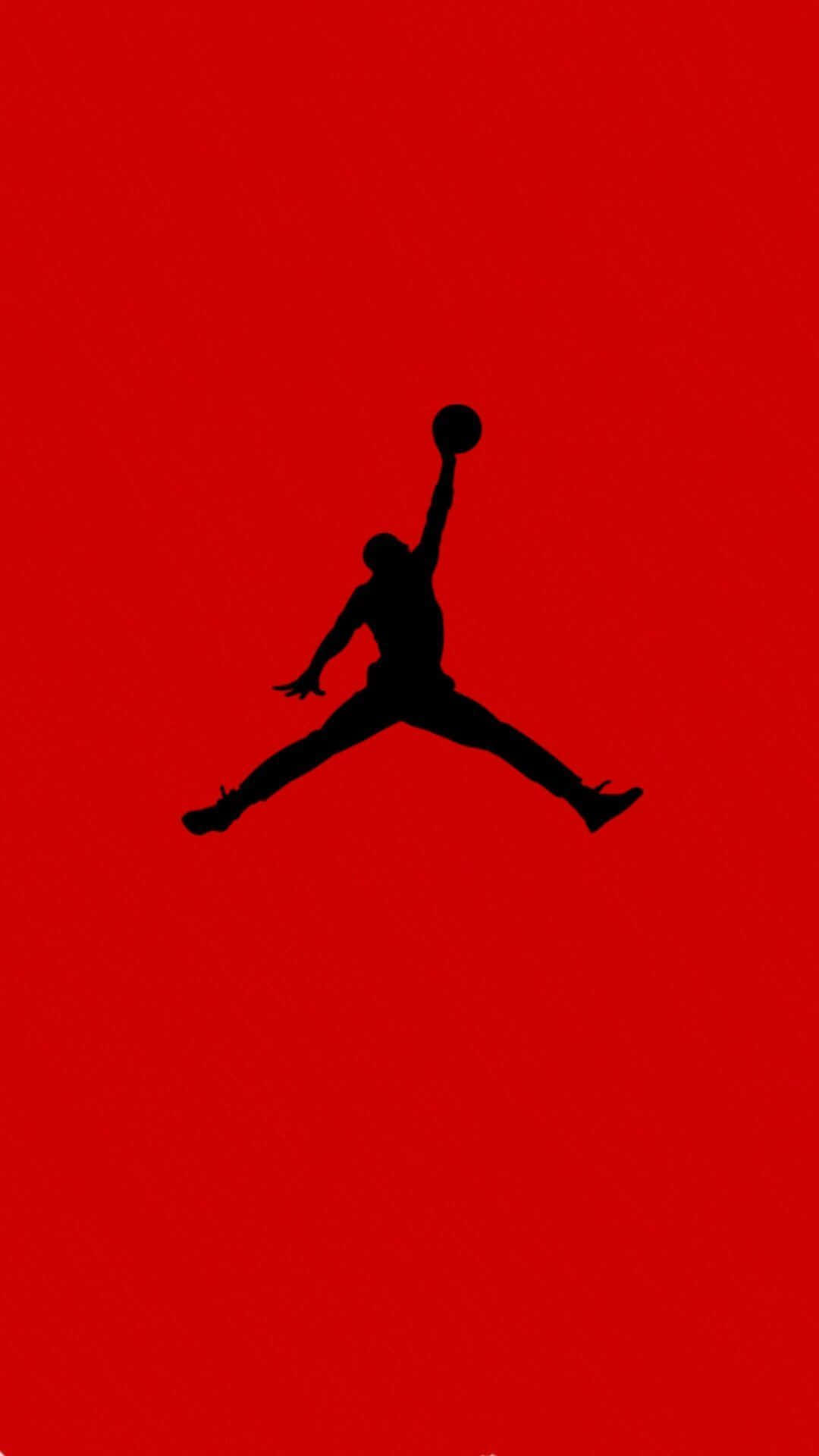 Eineschwarze Silhouette Eines Jordan-jumpers Auf Rotem Hintergrund. Wallpaper