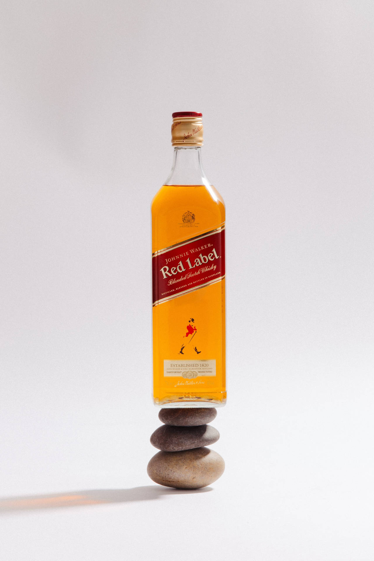 Botellade Whiskey Red Label Sobre Pila De Piedras Fondo de pantalla