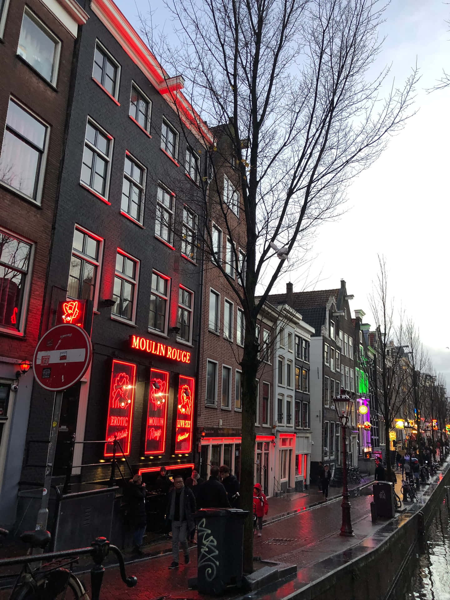 Vibrant colors illuminating the iconic Red Light District at night. Wallpaper