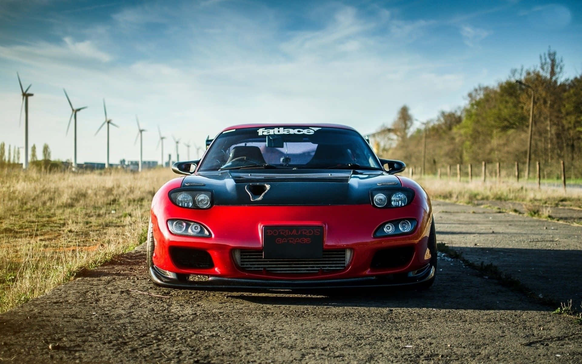 Red Mazda Rx 7 Against Windmill Wallpaper