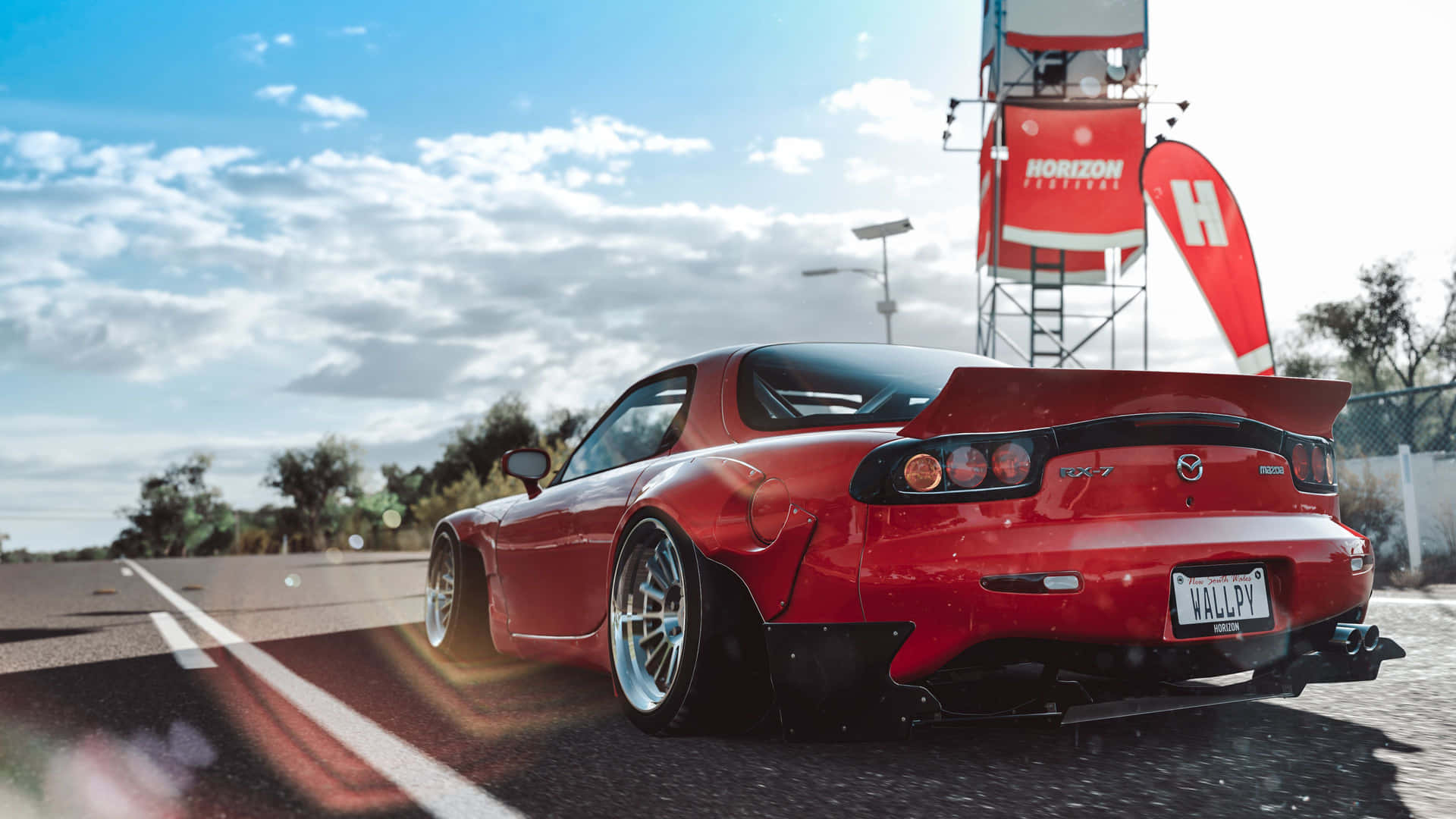 "High-speed Red Mazda RX-7 Making a Curve on a Racetrack" Wallpaper