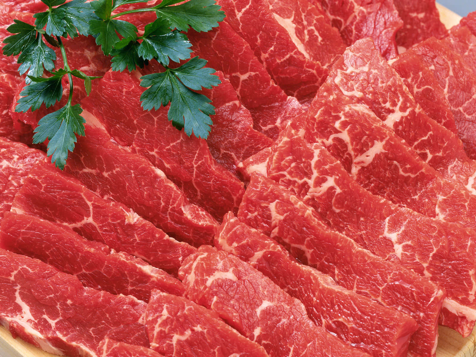 Fresh raw red meat on a cutting board Wallpaper
