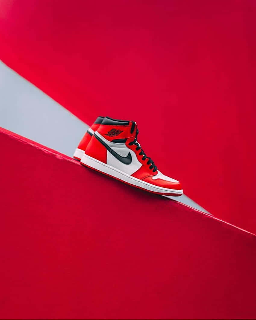 Elevate Your Game with Red Nike Jordan Air 1 Shoes Wallpaper