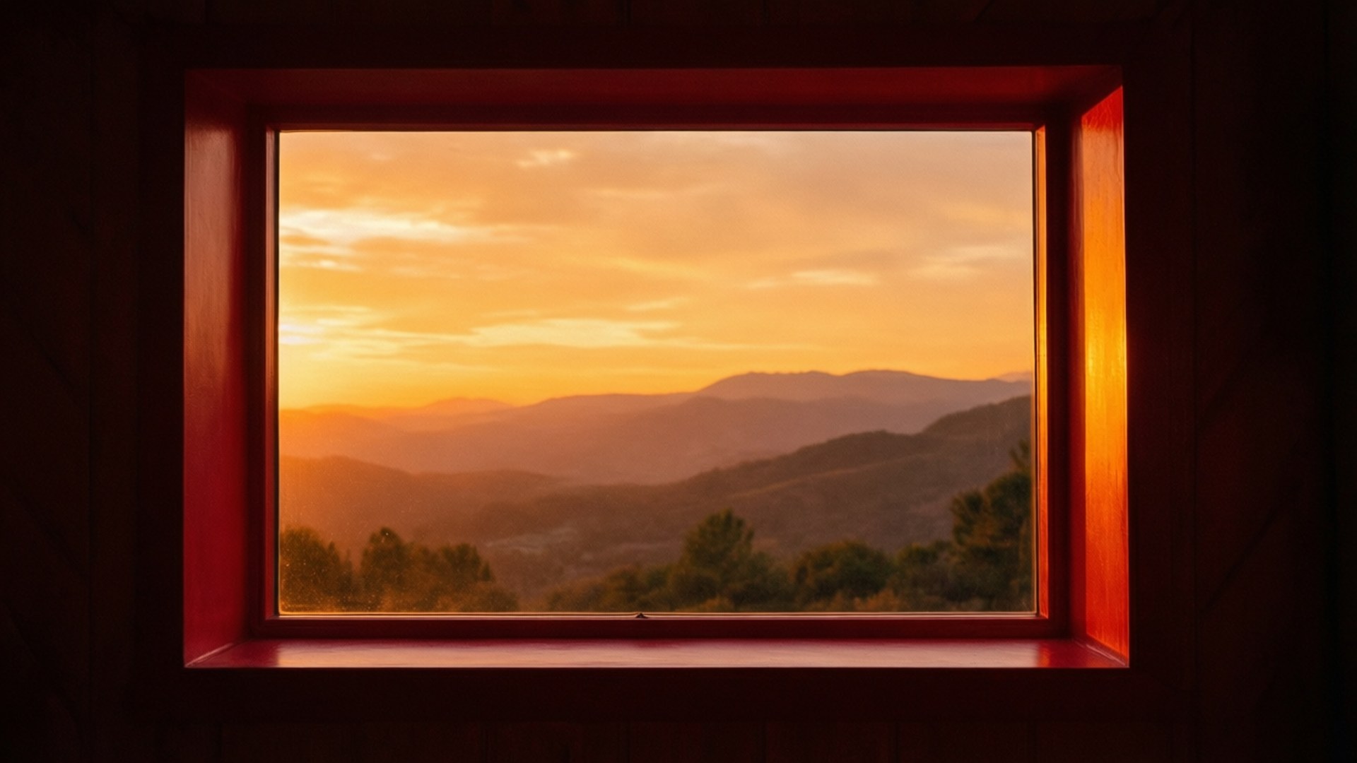 Sunset view through a wooden window overlooking mountain ranges and forest
