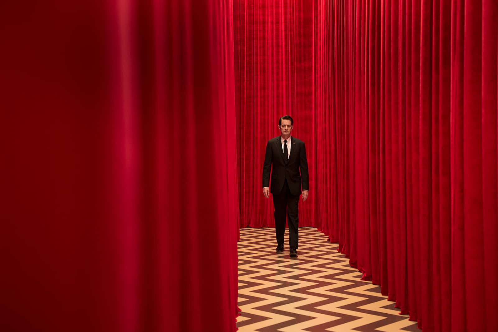 Man Wearing Suit In Red Room Picture