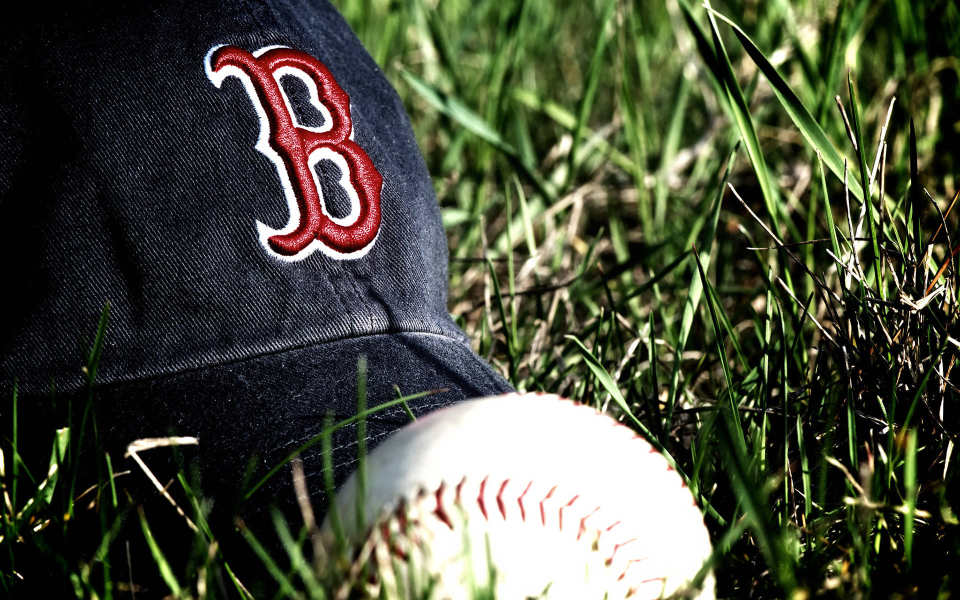 Red Sox Baseball Hat On Grass Wallpaper