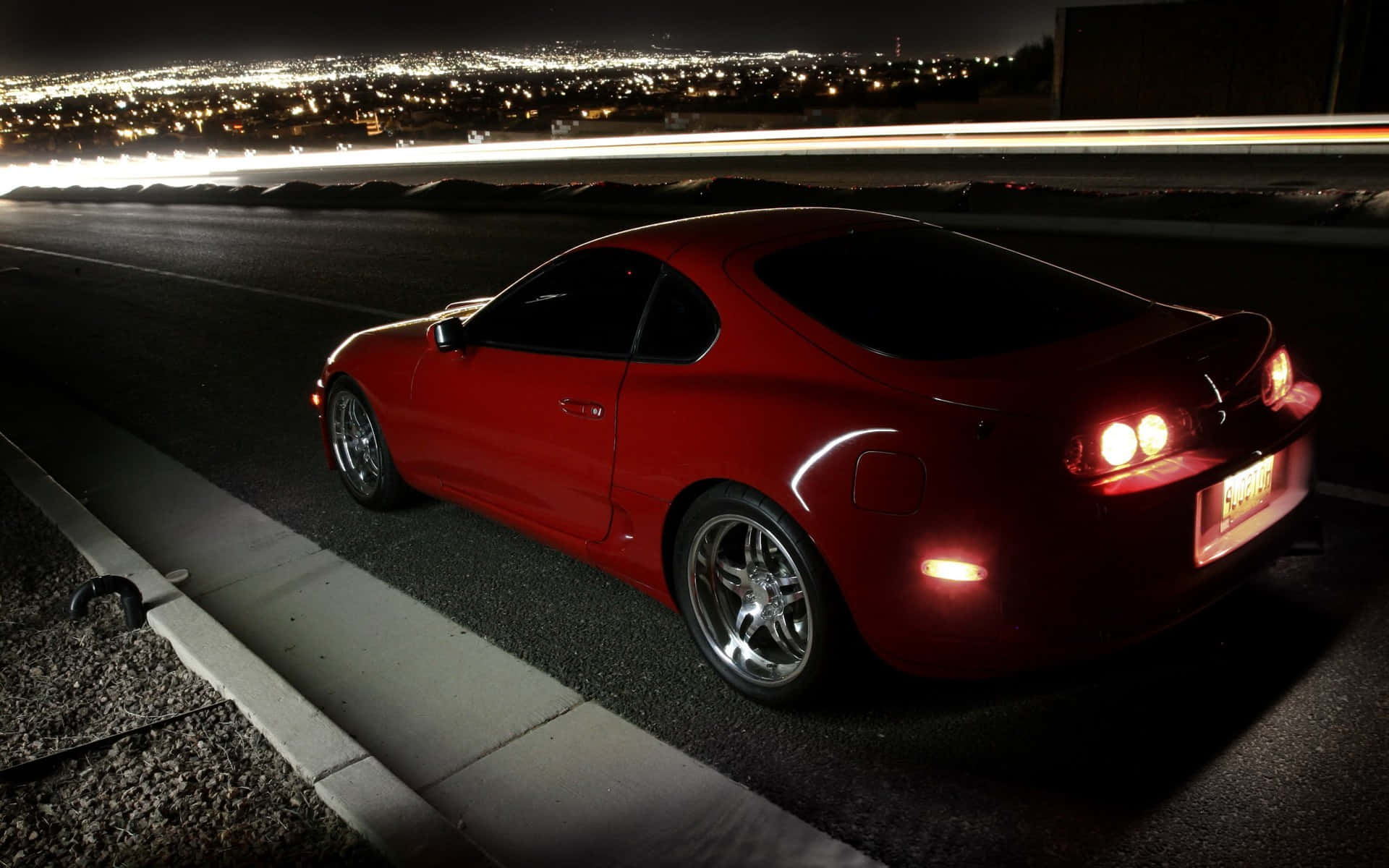 Red Sports Car Nighttime Cityscape Wallpaper