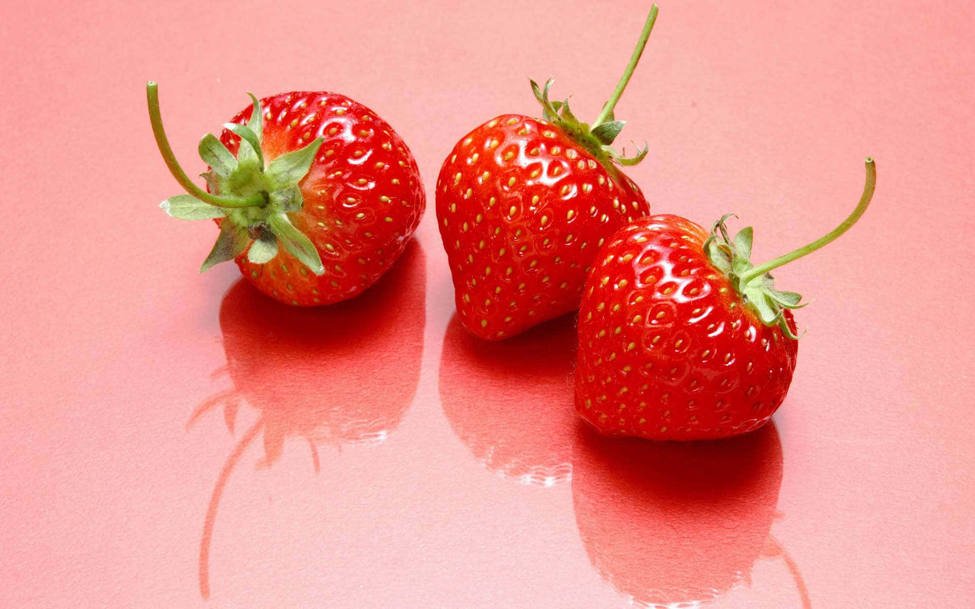 Fresh Red Strawberries on Display Wallpaper