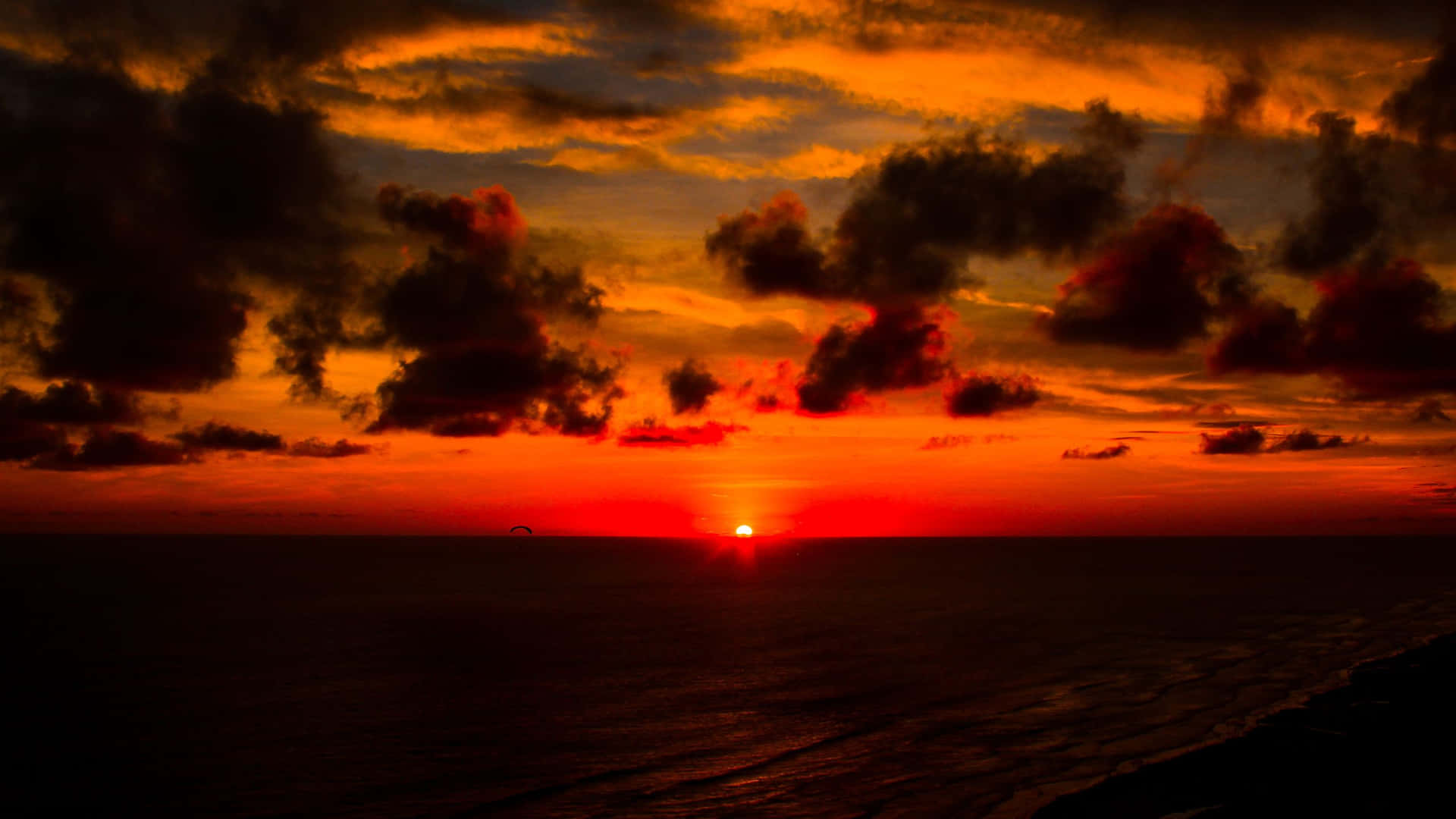 Captivating Red Sunset Over the Horizon Wallpaper