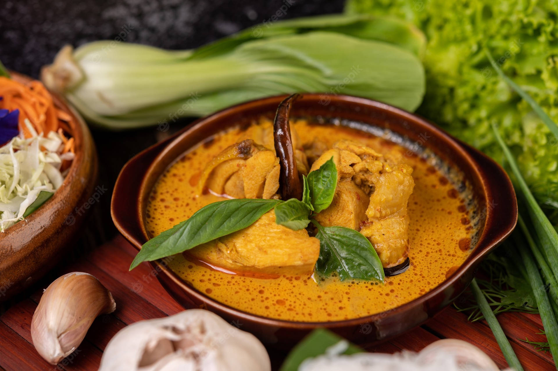 Caption: Vibrant and Spicy Red Thai Curry with Vegetables Wallpaper