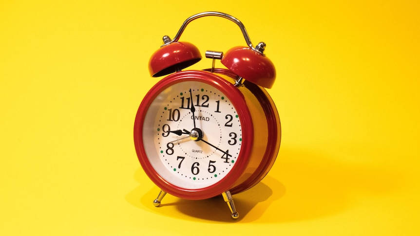 Precise Red Alarm Clock Displaying Time Wallpaper