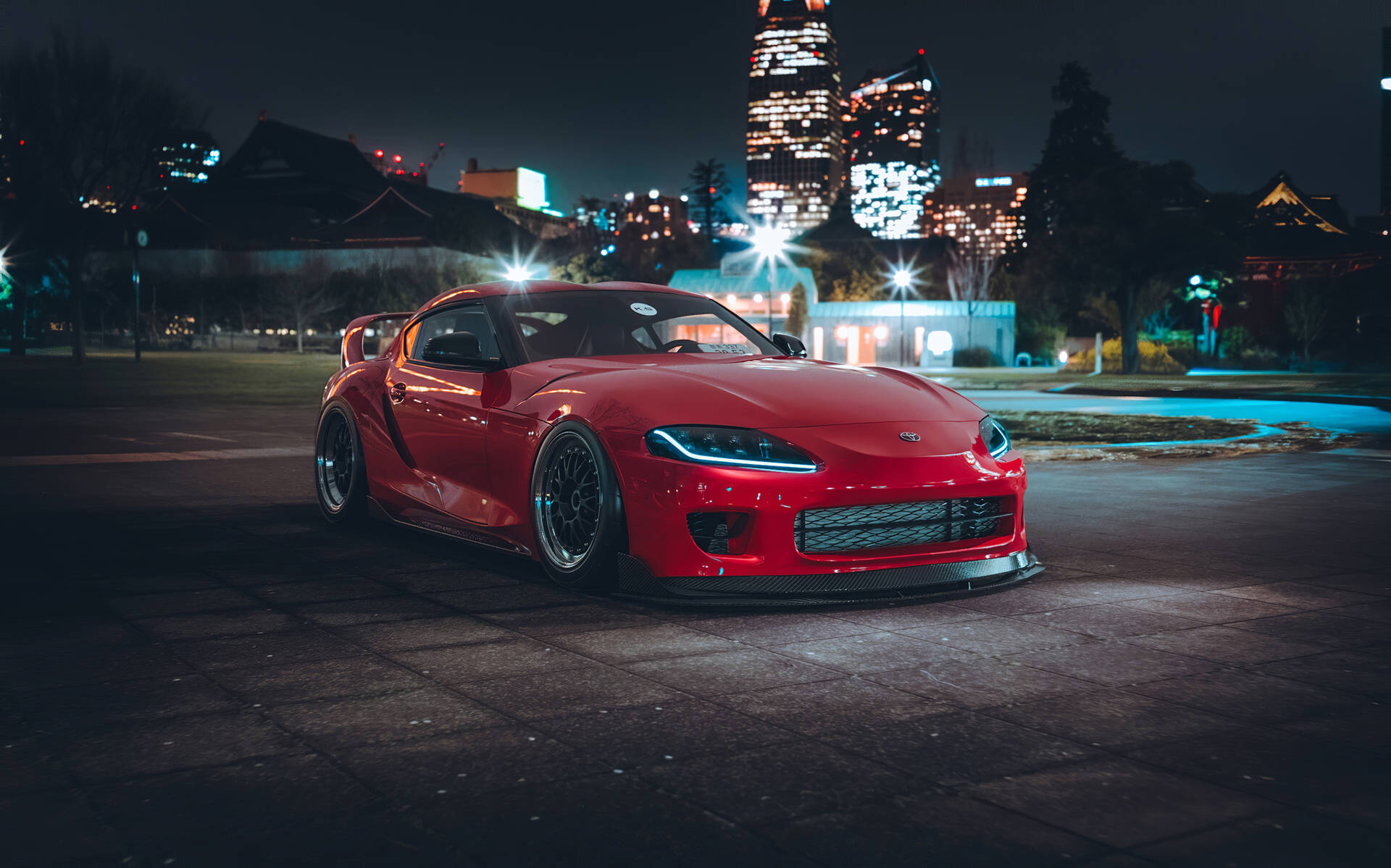 Red Toyota Supra Parked Near Cityscape Wallpaper