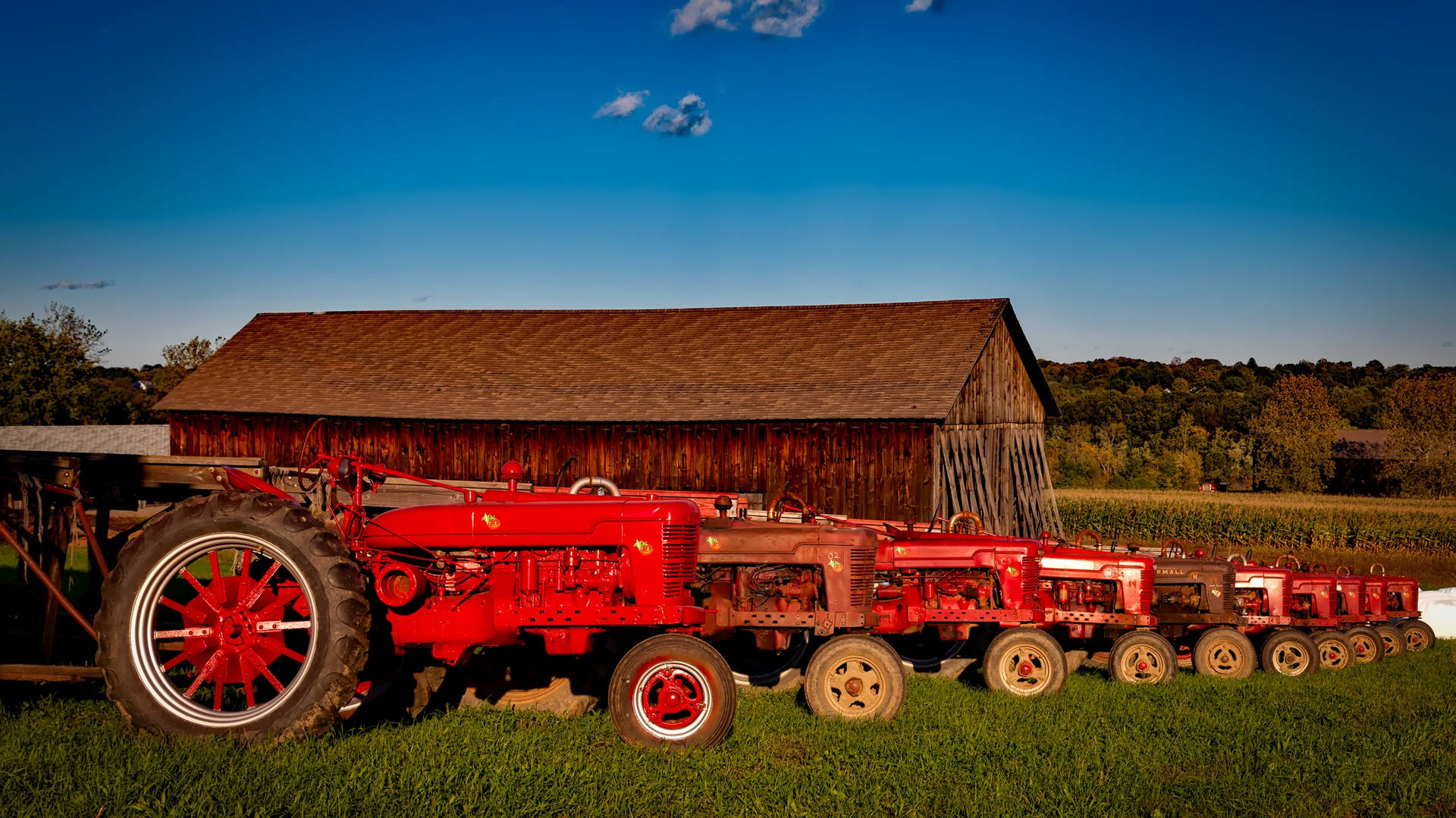Red Tractor Parked On The Field Wallpaper