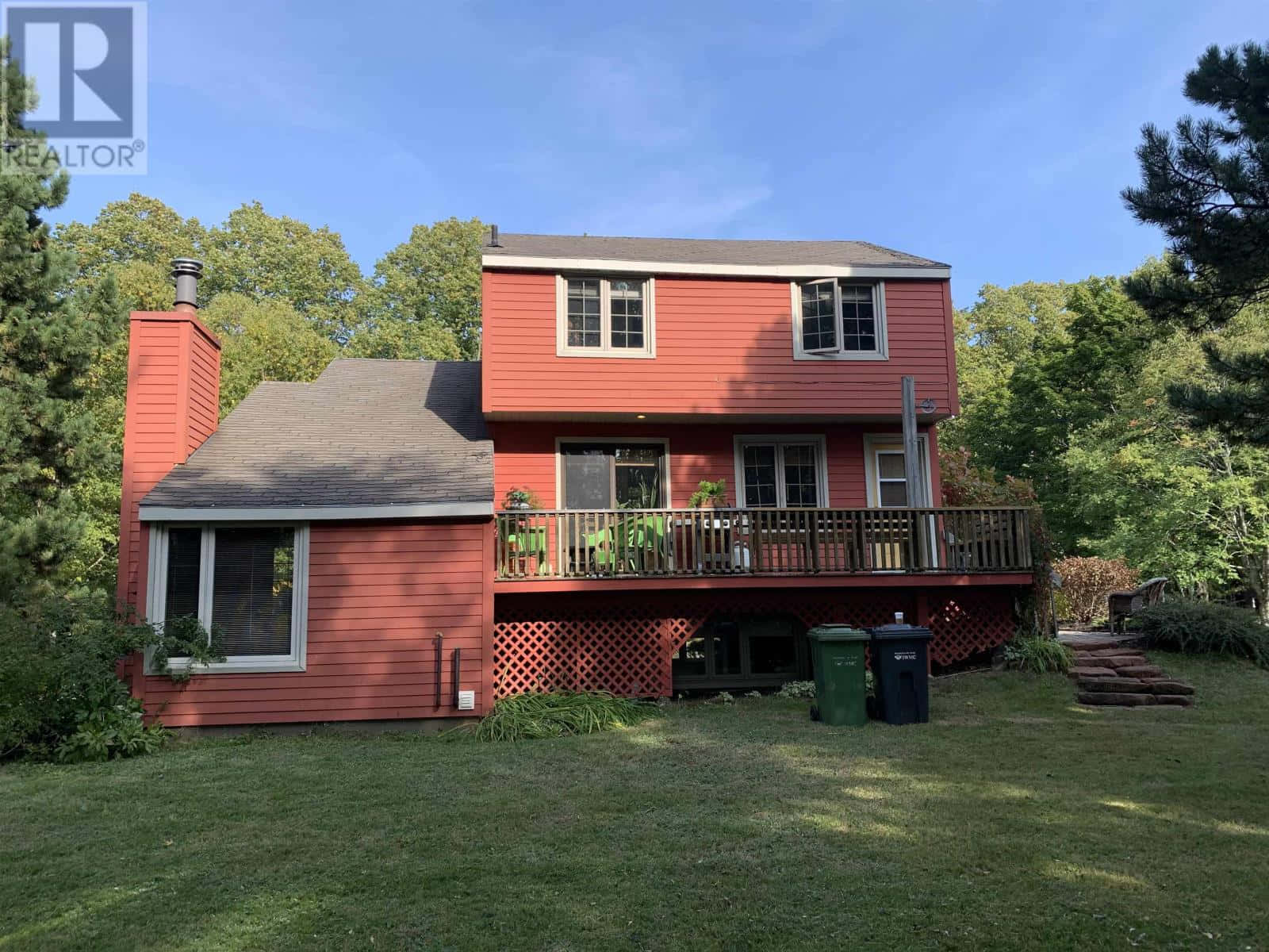 Red Two Story Housewith Deckand Green Lawn Wallpaper