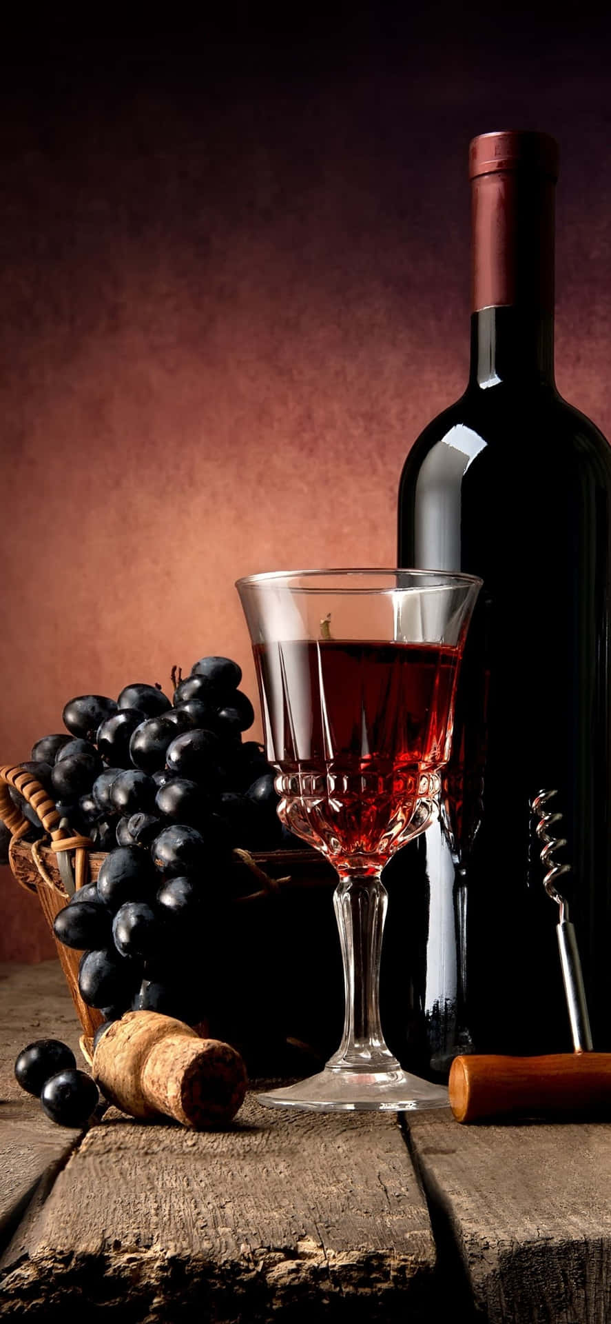 A luxurious red wine glass elegantly holding a rich full-bodied wine. Wallpaper