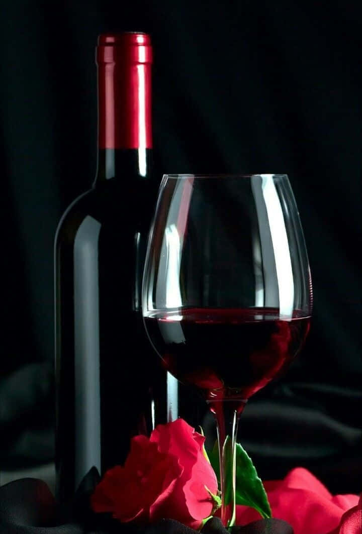 Elegant Red Wine Glass on a Table Wallpaper