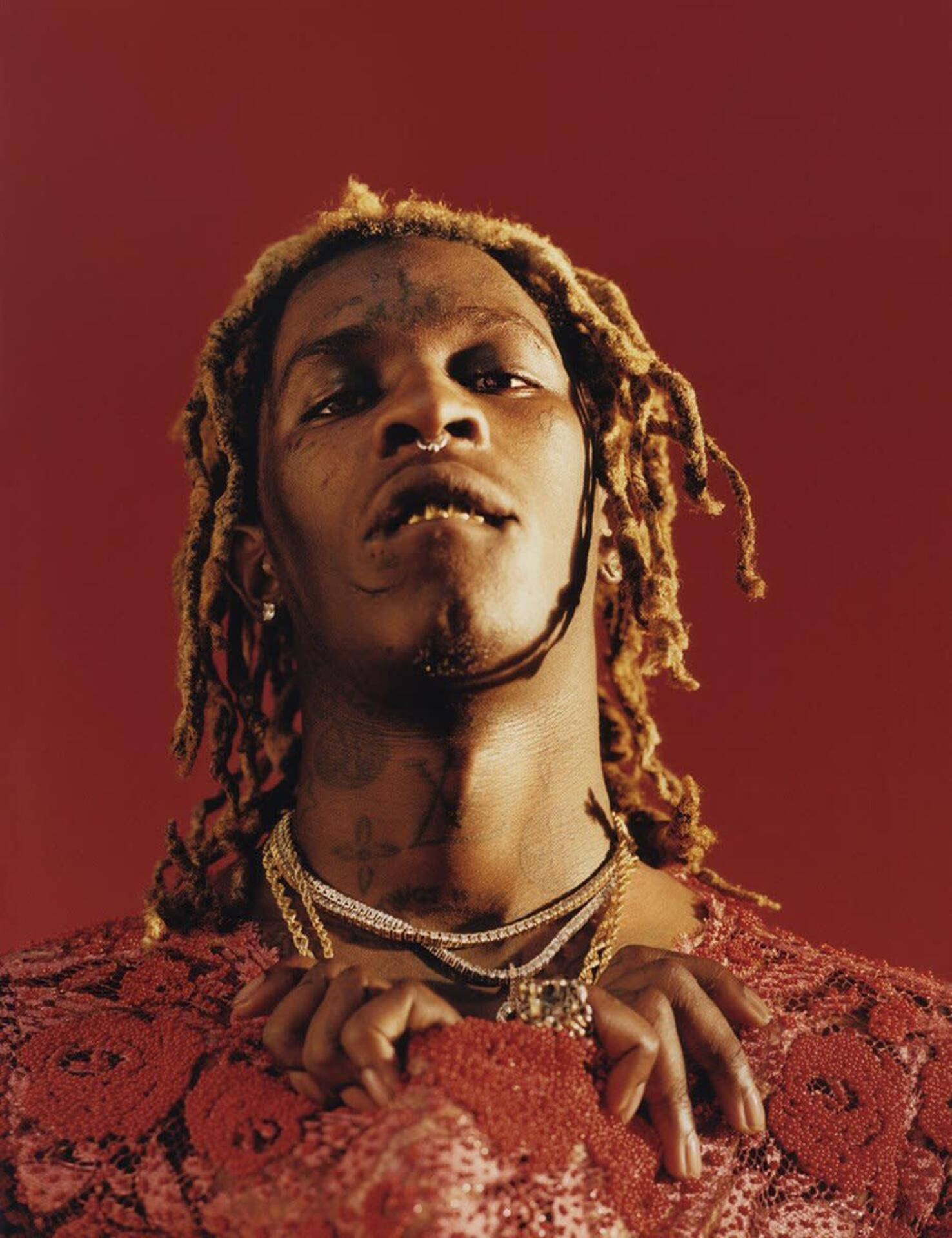 Young Thug posing by a red phone Wallpaper