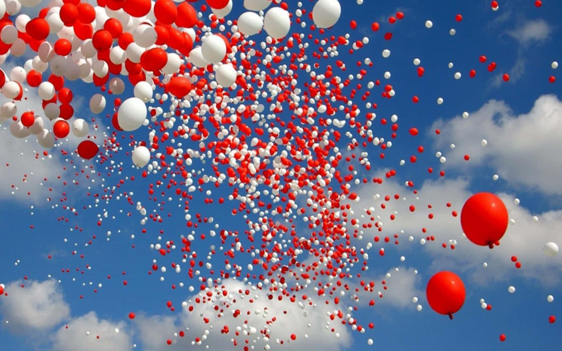 Redand White Balloons Against Blue Sky Wallpaper
