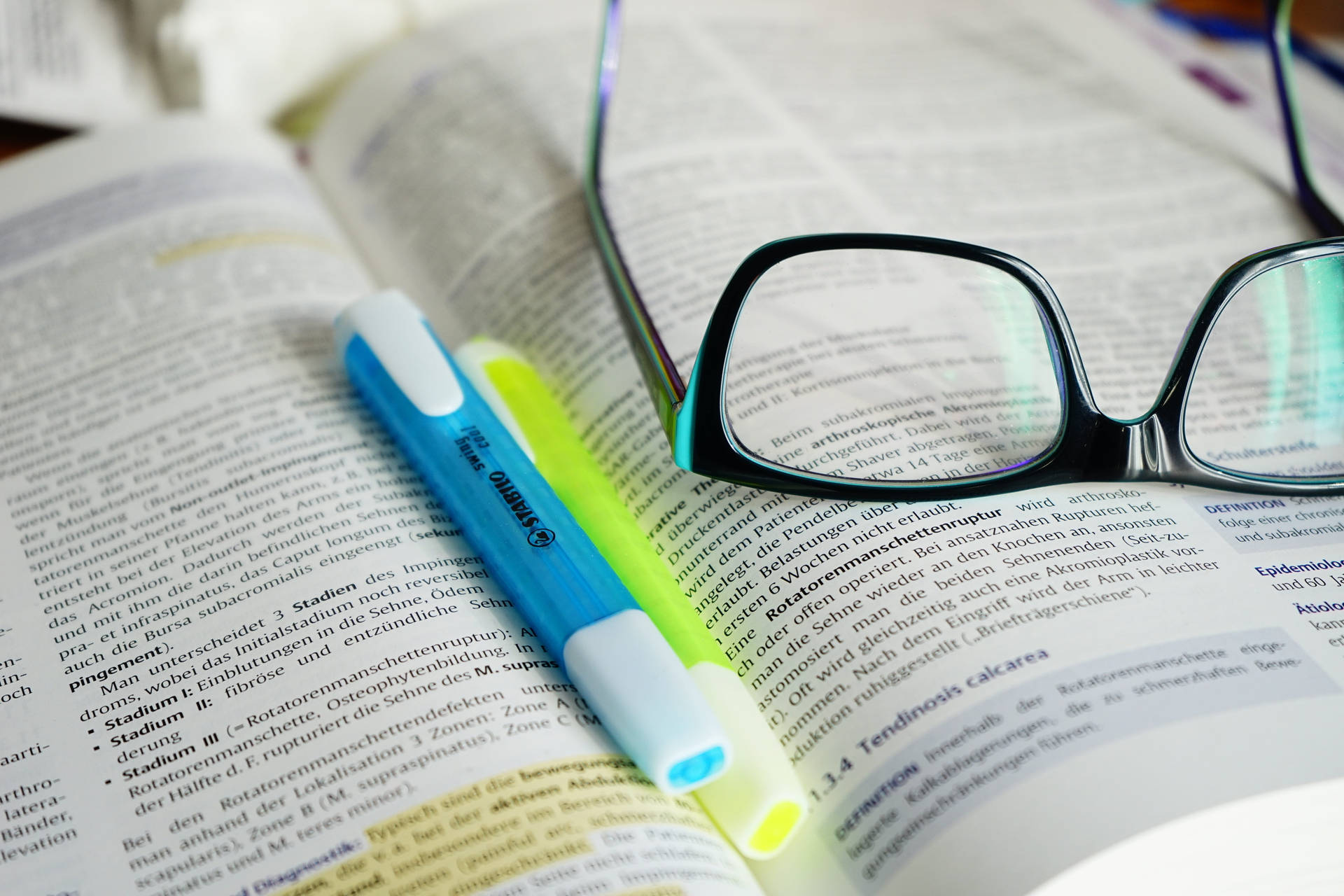 Reference Book With Highlighters And Eyeglasses Wallpaper