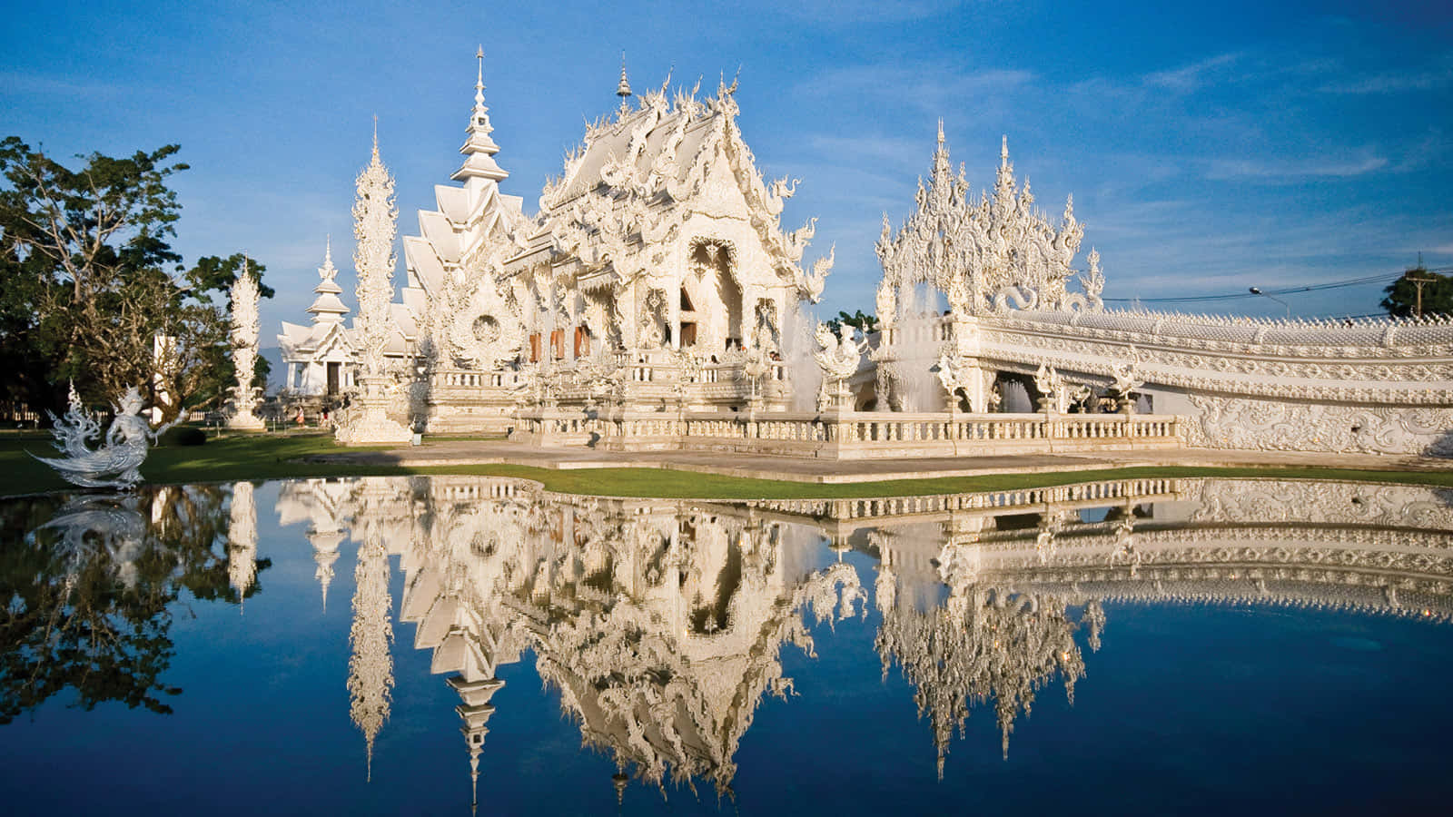 Reflection Of White Temple In Chiang Rai On The Water Wallpaper