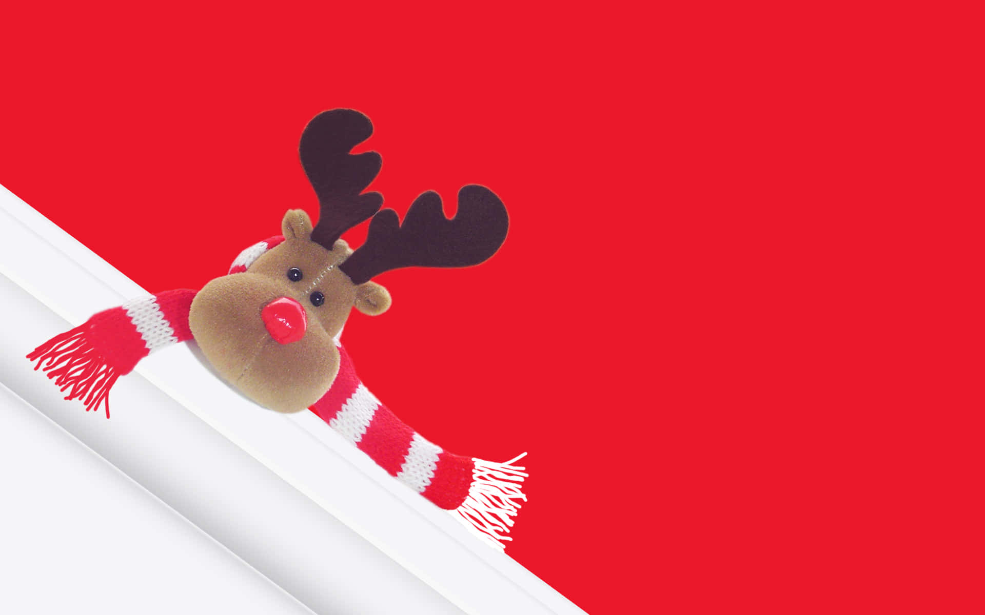 A Reindeer Is Sitting On A Red Background