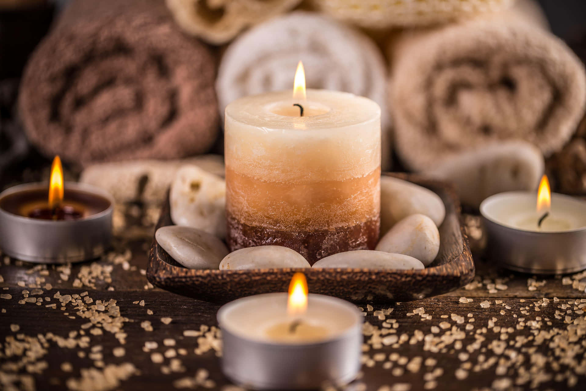 Relaxing Spa Experience Candlesand Towels Wallpaper
