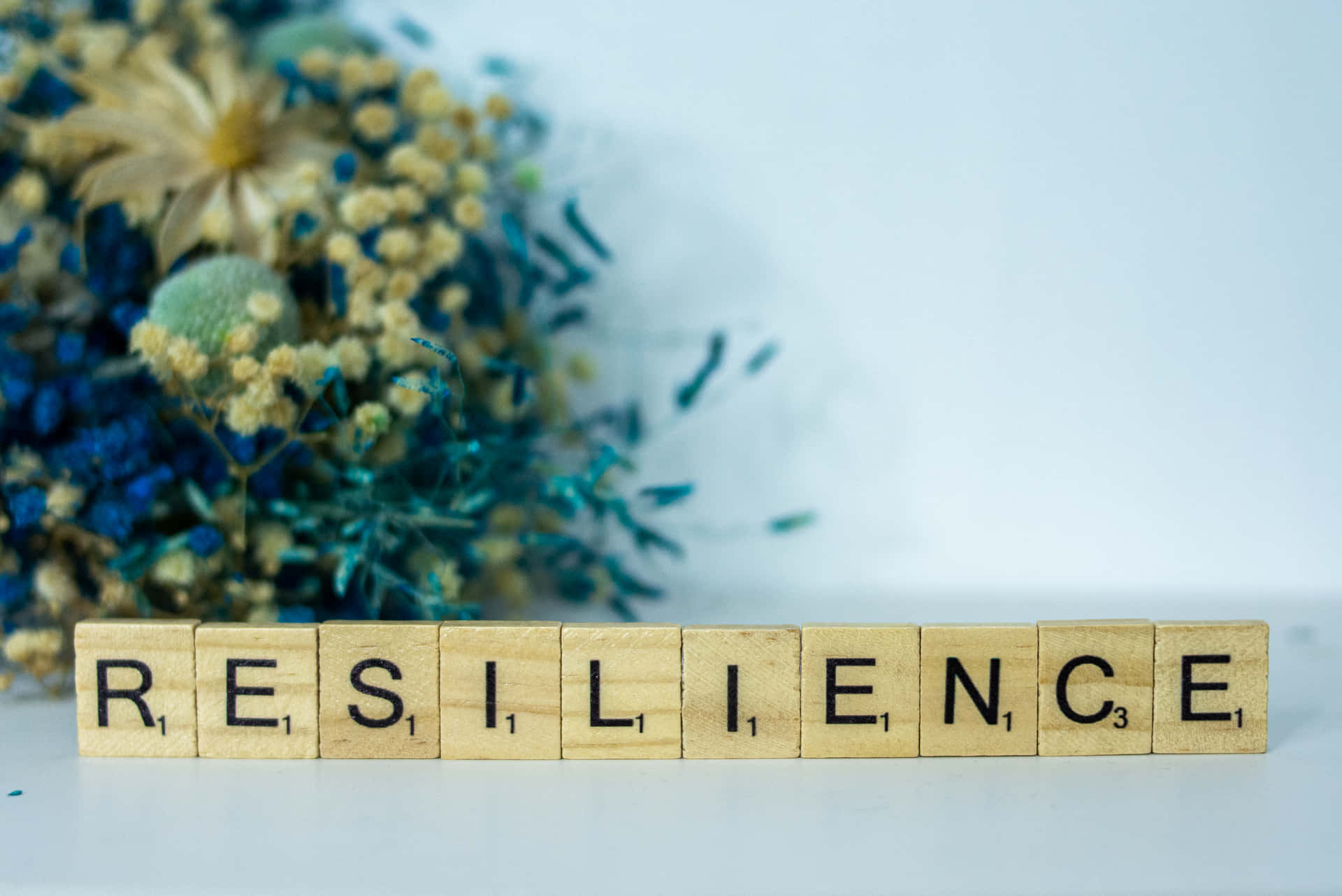 Reminder For People To Be Resilient In Scrabble Letter Tiles Wallpaper