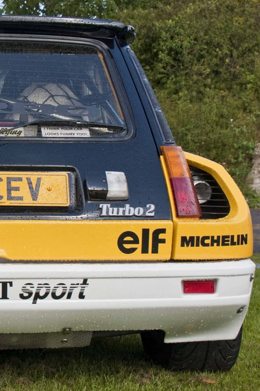 Vintage Renault 5 Turbo Parked at a Racing Event Wallpaper