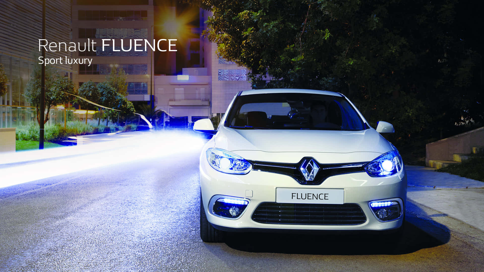 Sleek Renault Fluence in a Vibrant Cityscape Wallpaper