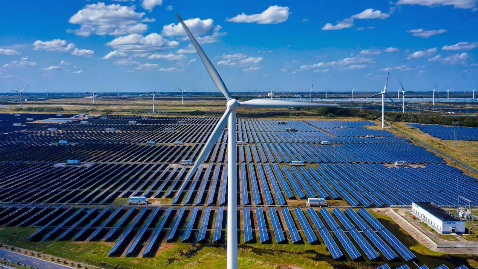 Renewable energy power plants against a beautiful blue sky Wallpaper