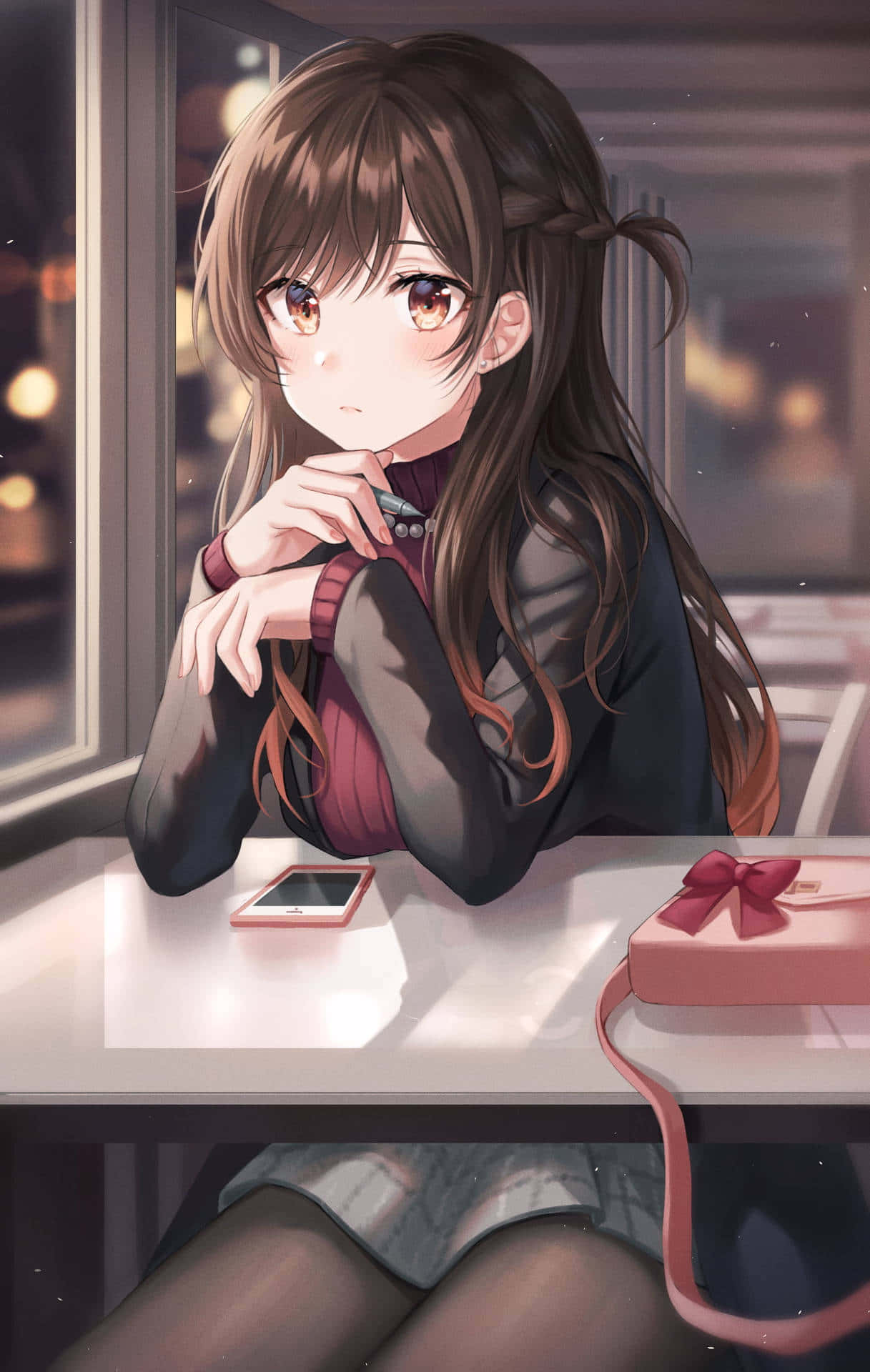 A Girl Sitting At A Table With A Gift Wallpaper