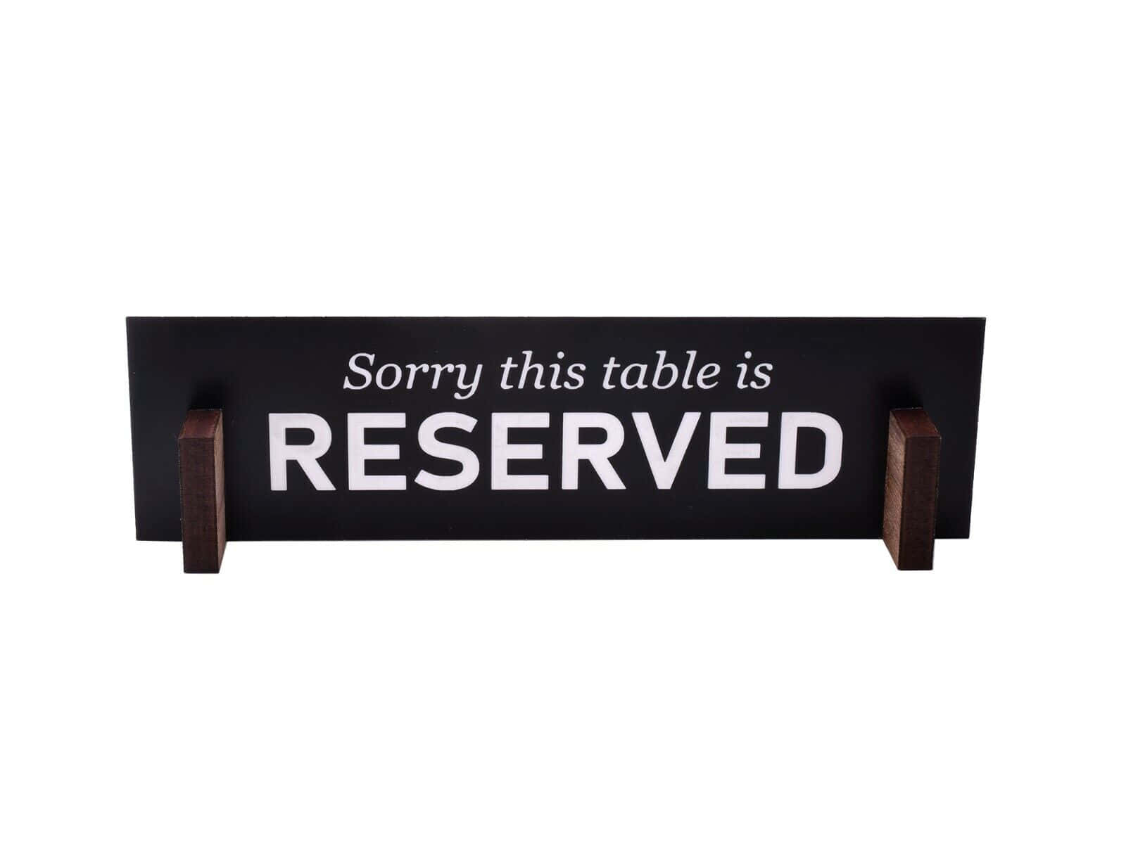 Elegant Wooden Reserved Sign on a Restaurant Table Wallpaper