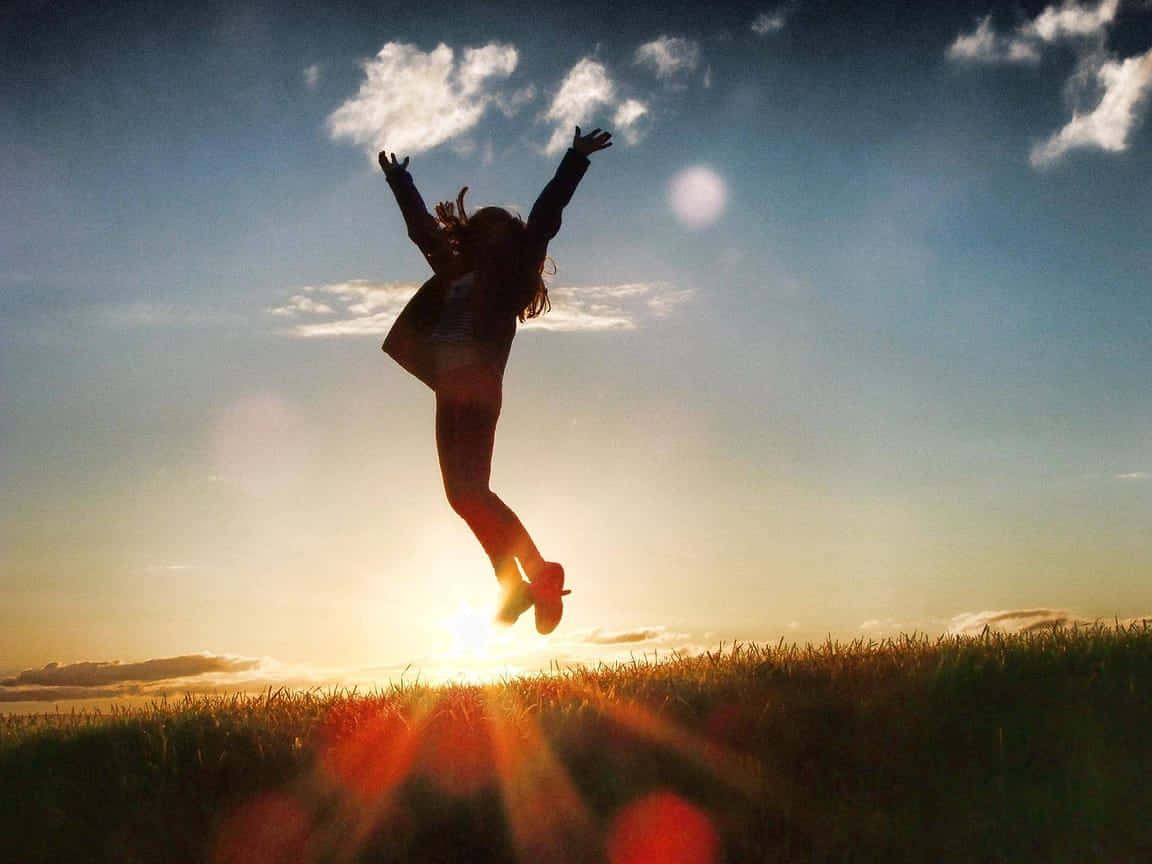 Resilient Person Jumping In Joy Wallpaper