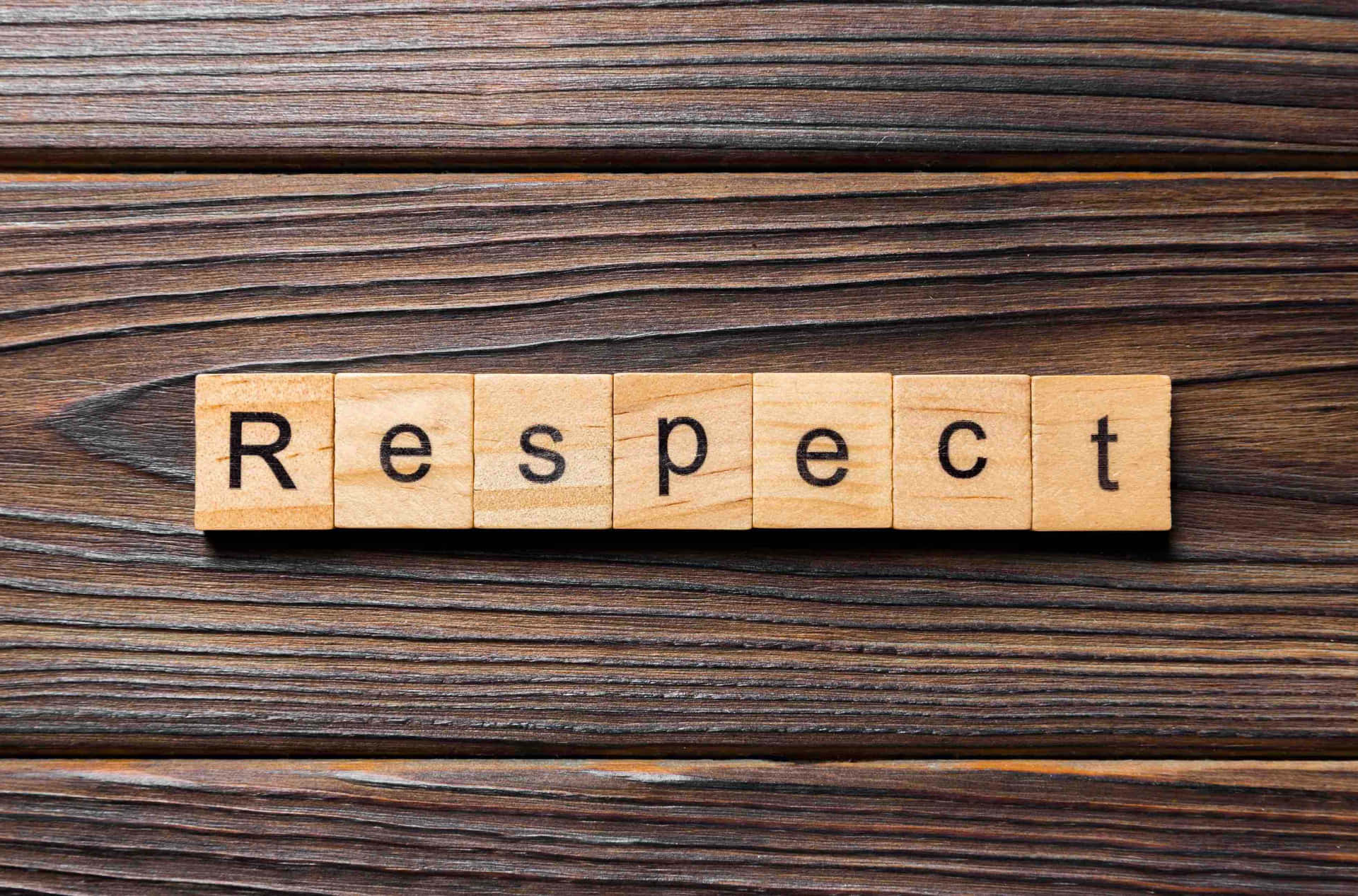 The Word Respect Spelled Out On A Wooden Background