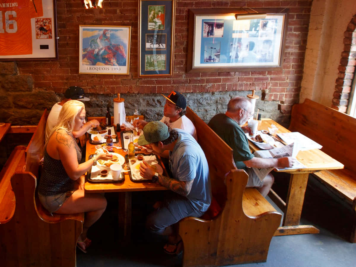 A Group Of People Eating In A Restaurant