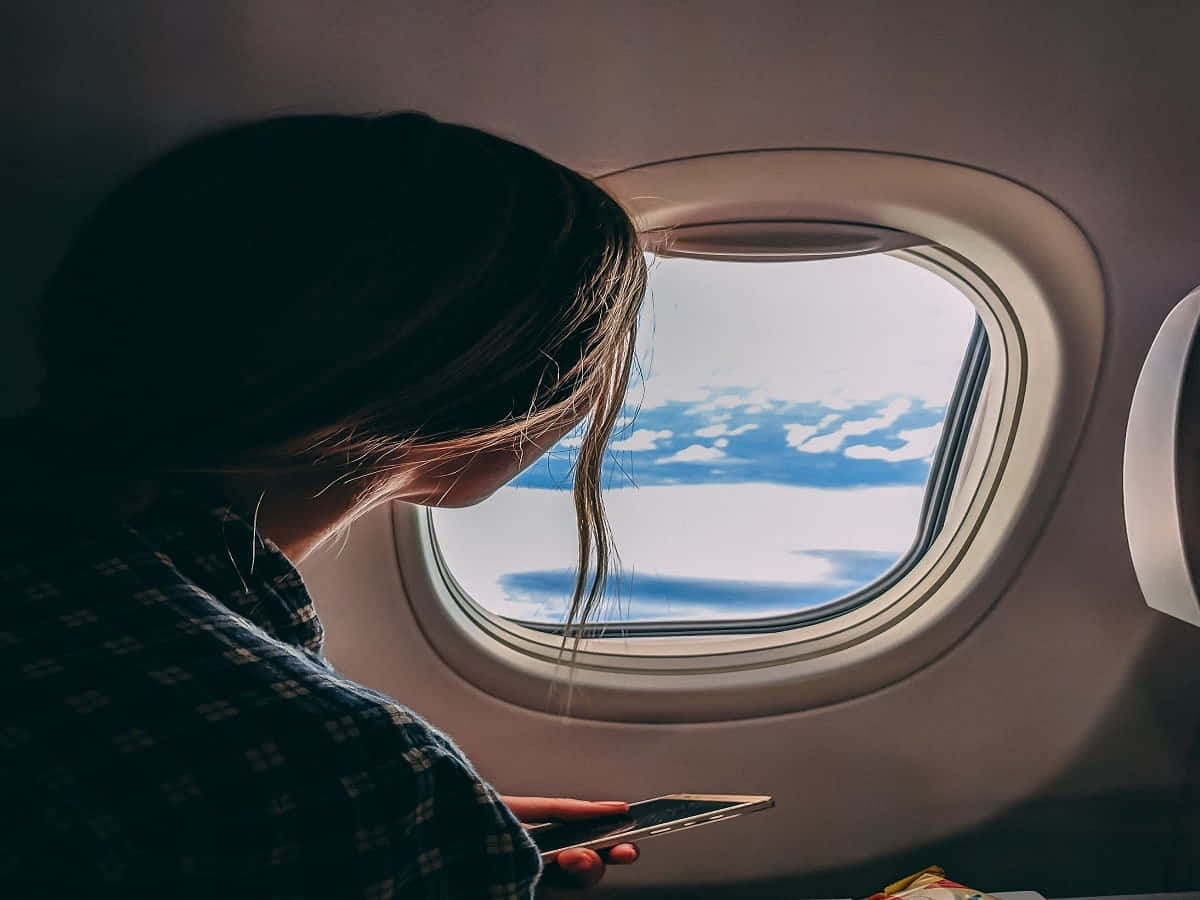 Restless Woman On A Plane Wallpaper