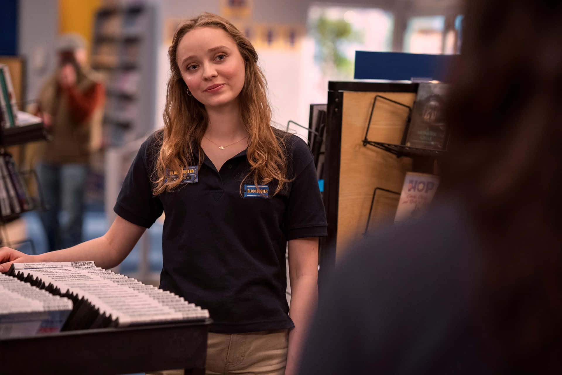 Retail Worker Smilingat Customer Wallpaper