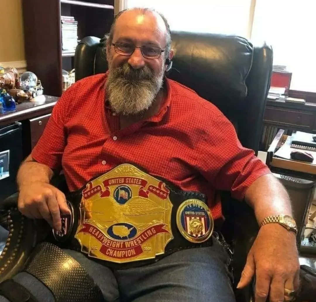 Retired Pro Wrestler Magnum TA proudly showcasing his NWA US Title Belt Wallpaper