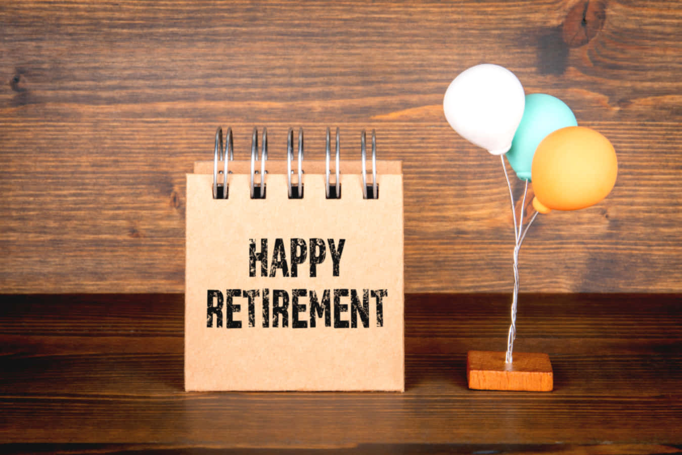 Happy Retirement Note With Balloons On Wooden Background