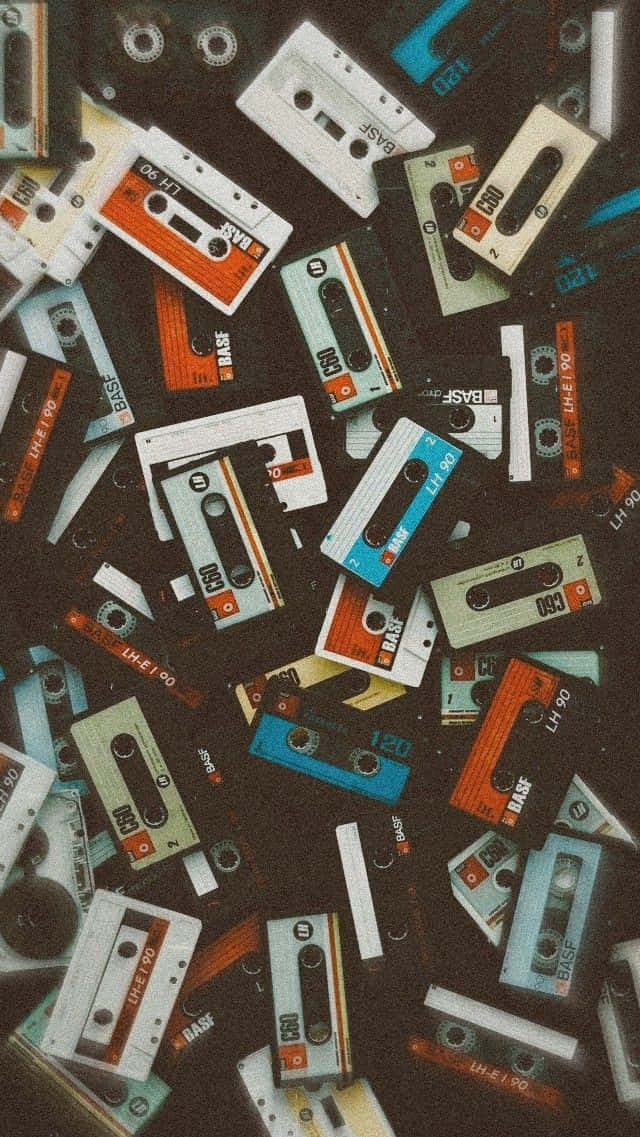 A Pile Of Cassettes On A Black Background