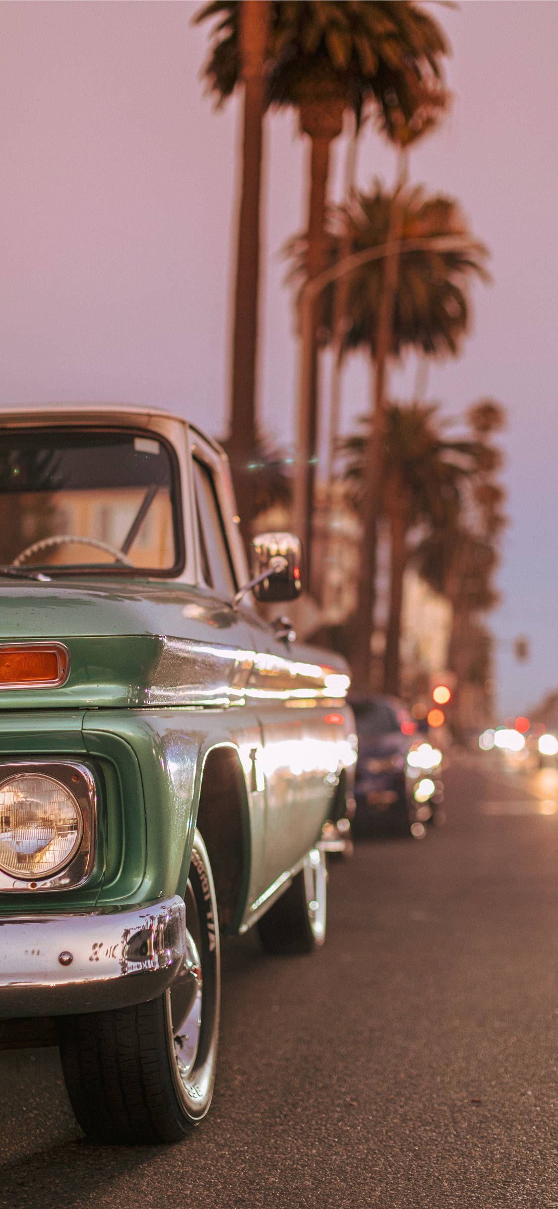 Vintage Car Parked By Palm Trees Wallpaper