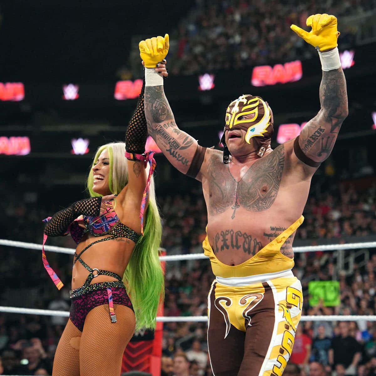 Rey_ Mysterio_ Victory_ Celebration_with_ Female_ Wrestler Wallpaper