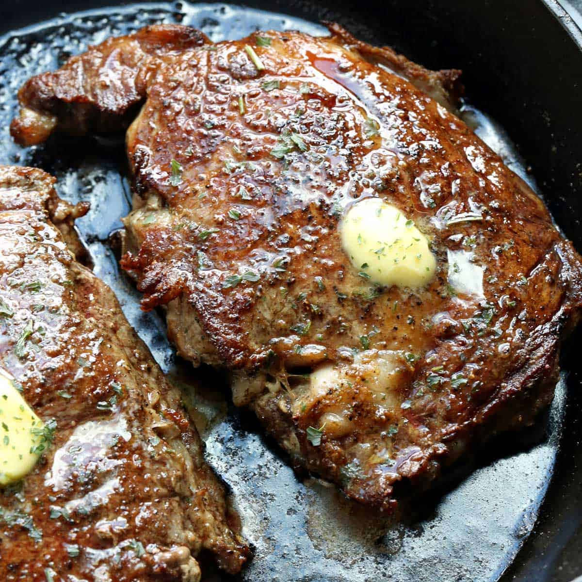 Two Steaks In A Skillet With Butter
