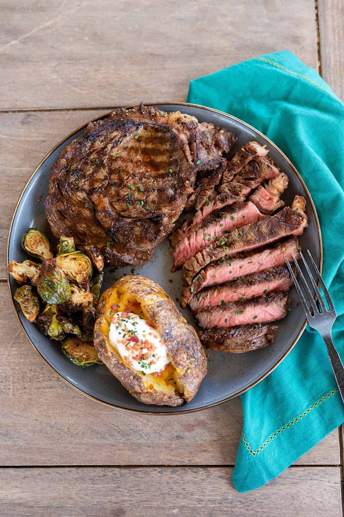 A Plate With Steak, Potatoes And Brussels Sprouts