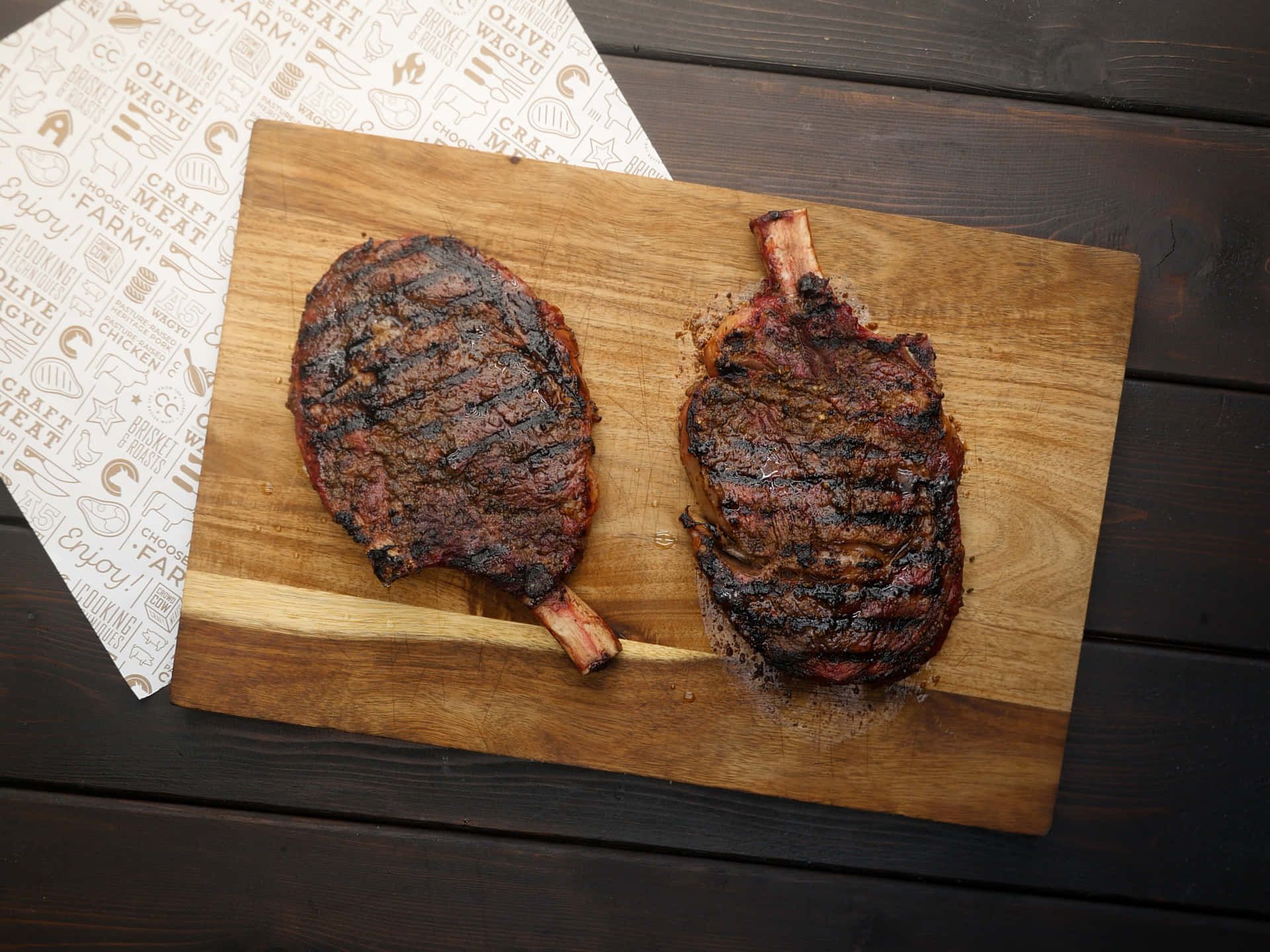 Two Grilled Steaks On A Wooden Cutting Board
