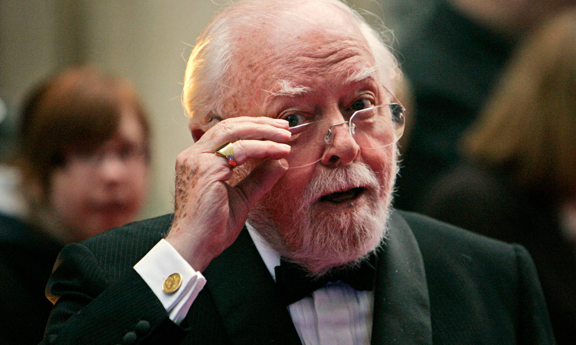 Richard Attenborough Contemplatively Holding His Glasses Wallpaper