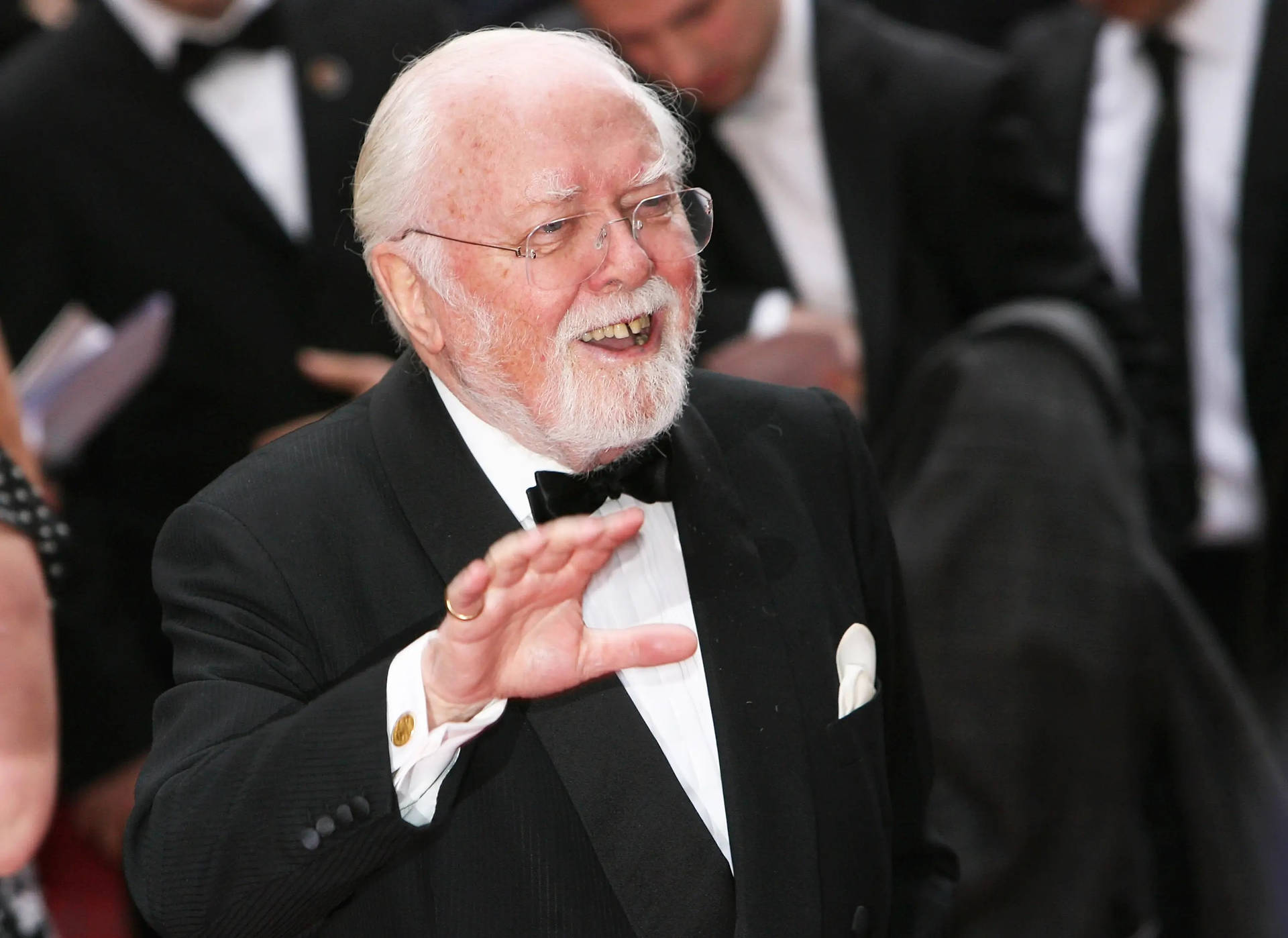 Caption: Richard Attenborough Enthusiastically Waving on the Red Carpet Wallpaper
