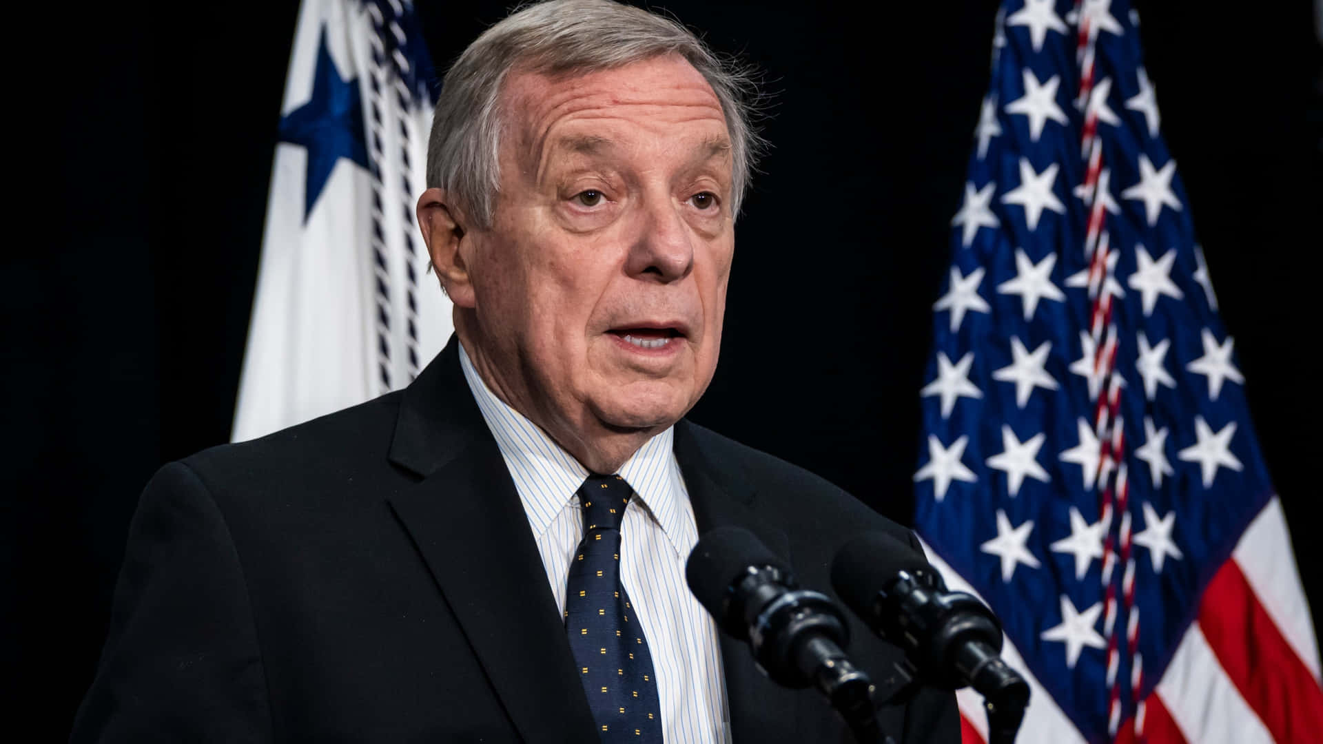 Richard Durbin With Flags In Background Wallpaper
