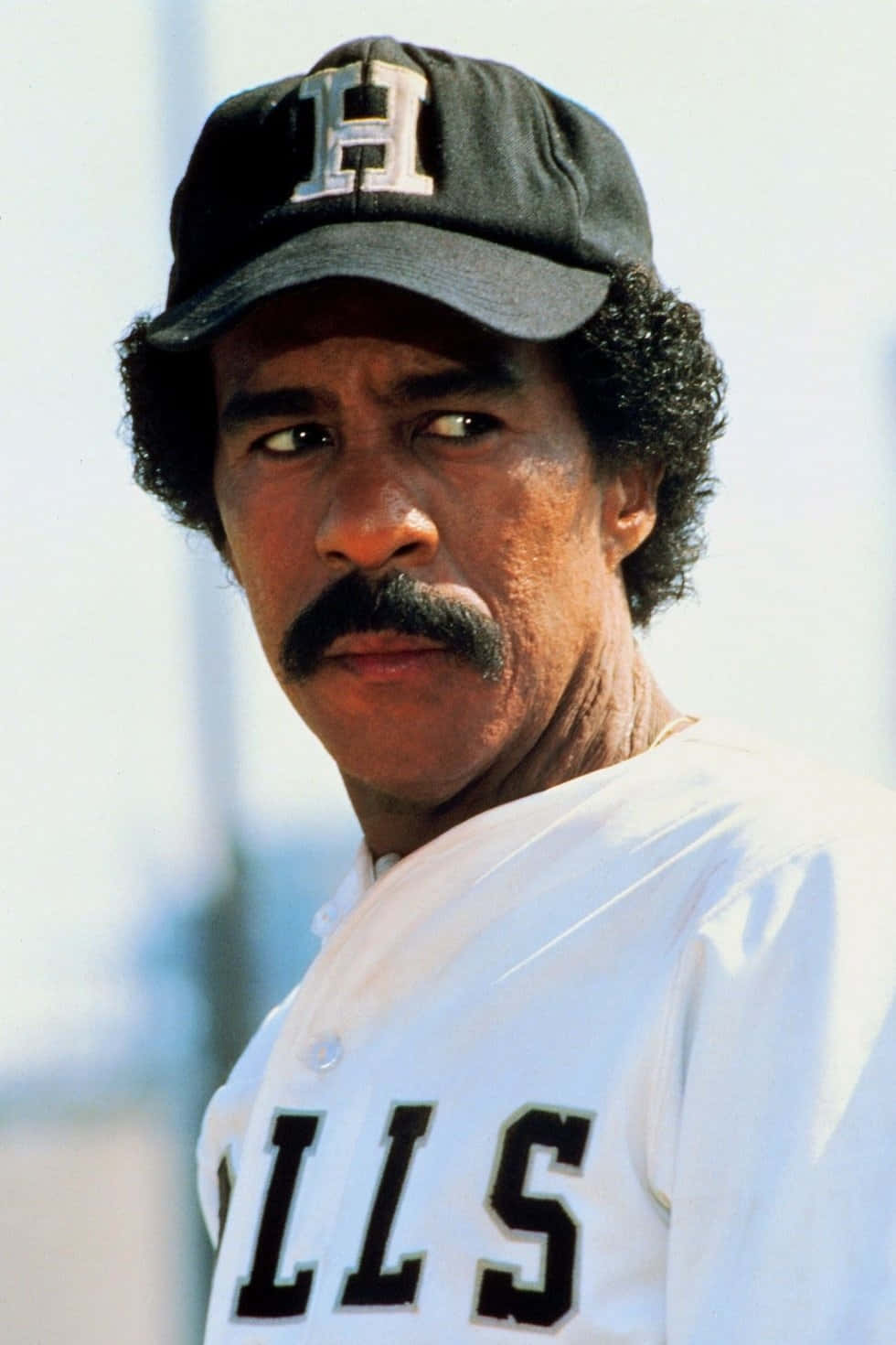 Iconic comedian Richard Pryor posing for a portrait Wallpaper