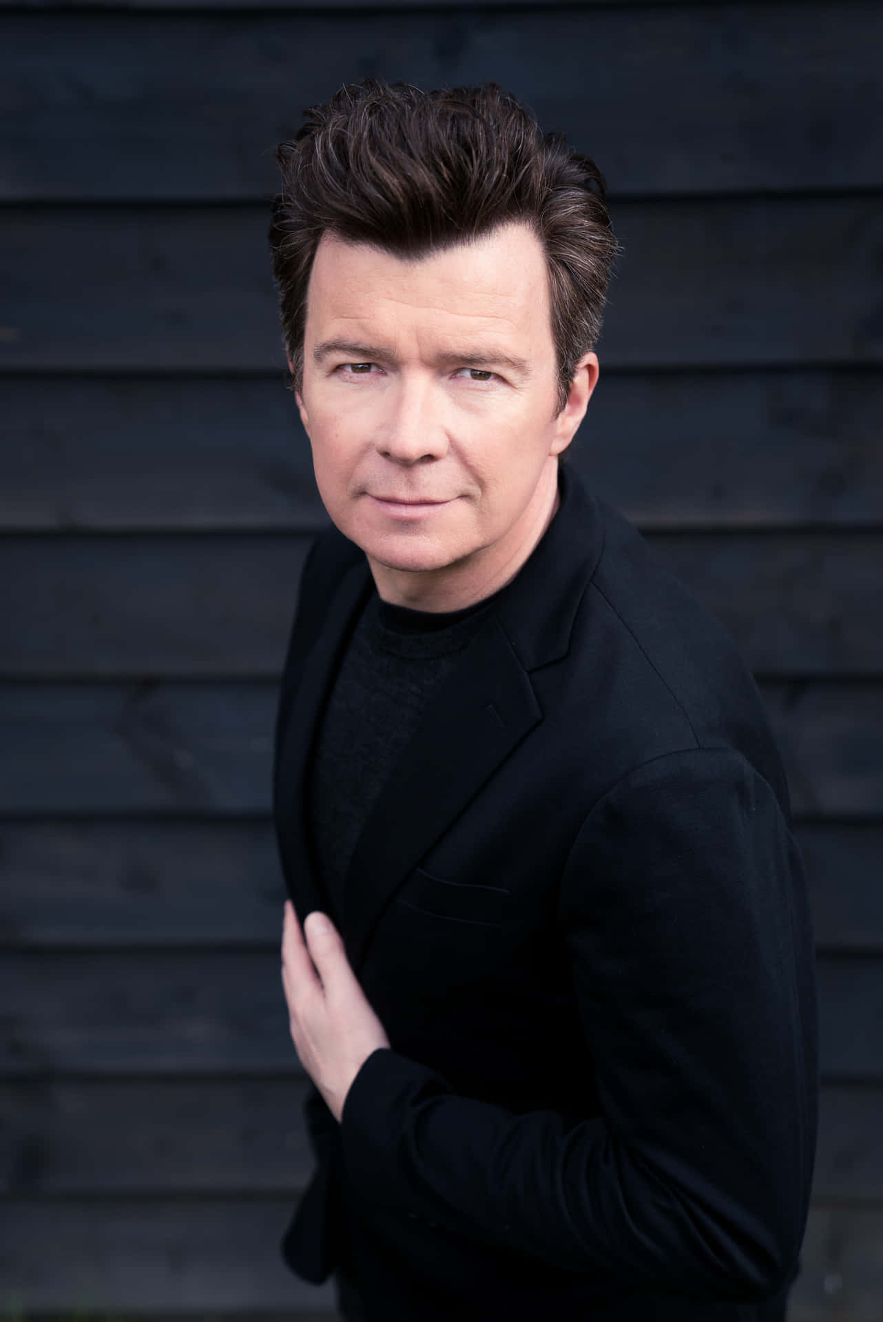 The pop star Rick Astley in his signature style. Wallpaper